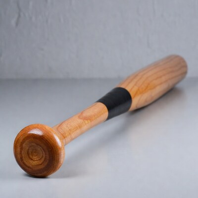 Wooden Baseball Bat on Gray Surface