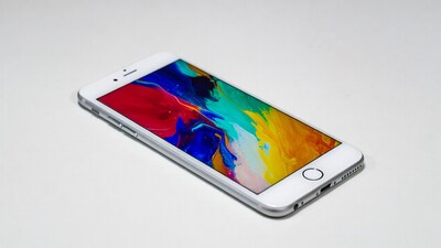 White iPhone with colorful abstract wallpaper