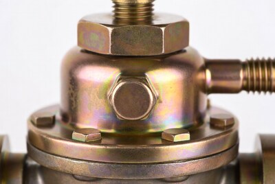 Closeup of brass valve with bolts