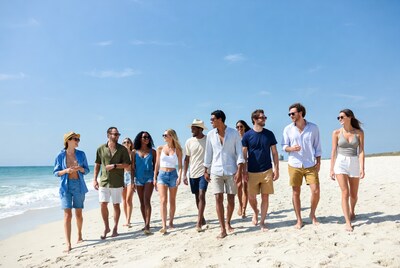Diverse group walking on beach