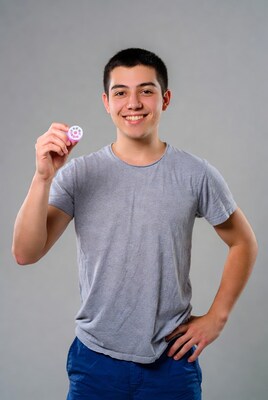 Young man holding pink dental dam