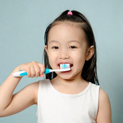 Asian girl brushing teeth