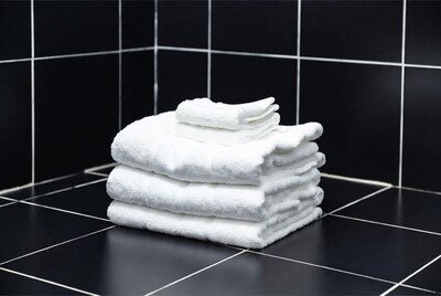 Stacked White Towels on Black Tiles