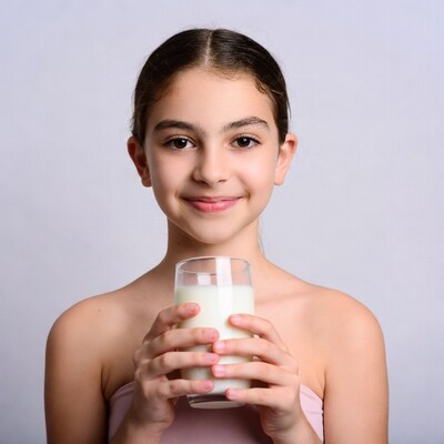 Girl holding glass of milk