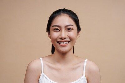 Asian woman smiling in white camisole