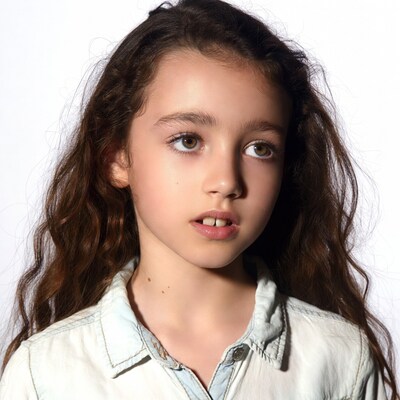 Girl with curly brown hair smiling