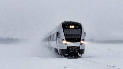 White train speeding through blizzard