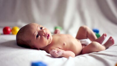 Newborn baby with colorful toys