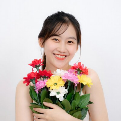 Asian woman holding colorful flowers