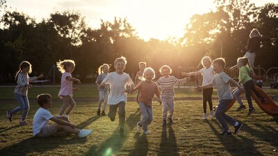 Children playing at playground sunset