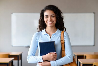Smiling Latina teacher holding book