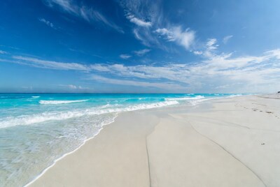 Turquoise waves on white sand beach