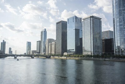 Skyscrapers along river with bridge