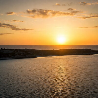 Sunset over rocky coastline and sea