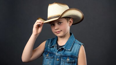 Boy tipping cowboy hat