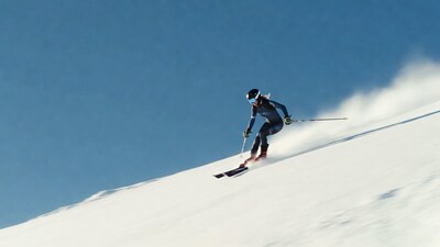 Woman skiing down snowy slope