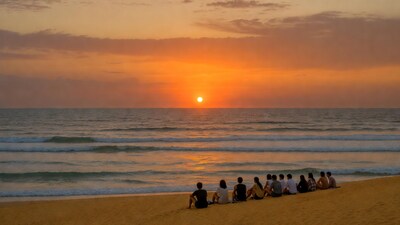 Group watching sunset on beach