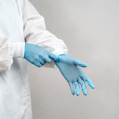 Person putting on blue gloves