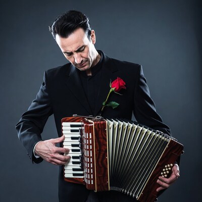 Man playing accordion in black suit