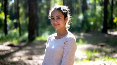 Teen girl smiling in forest