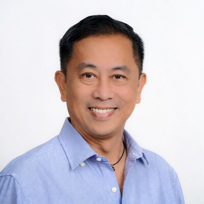 Asian man smiling in blue shirt