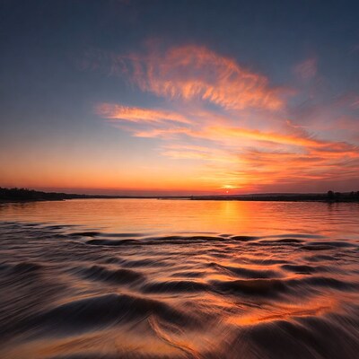 Sunset over rippling lake water