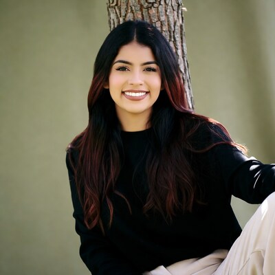 Smiling Latina woman by tree