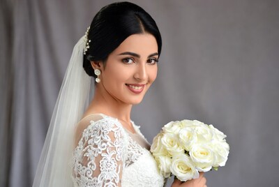 Bride holding white roses bouquet