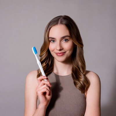 Woman holding blue toothbrush