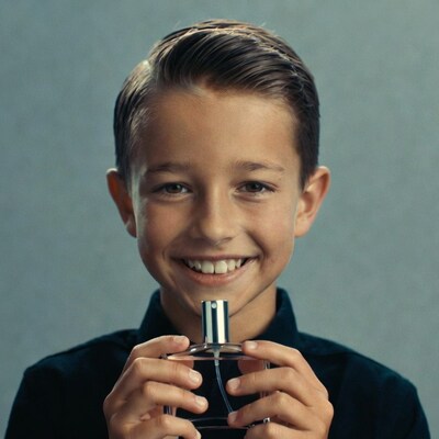 Boy holding perfume bottle