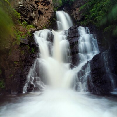 Majestic Waterfall Cascading Over Mossy Rocks