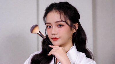 Asian woman holding makeup brush