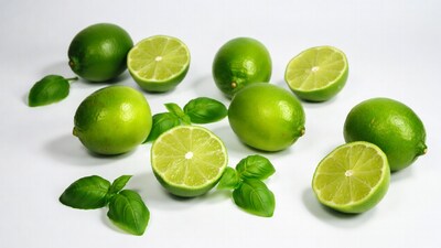 Fresh limes with basil leaves