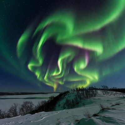 Vibrant Northern Lights over Snowy Landscape