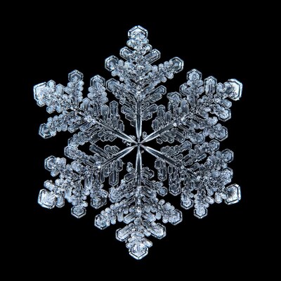 Detailed snowflake crystal on black background