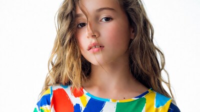 Girl with curly hair in colorful dress