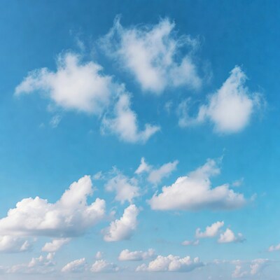 Fluffy white clouds in blue sky