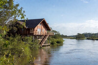 Wooden House on Stilts by River