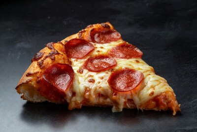 Pepperoni Pizza Slice on Black Background