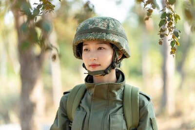 Asian woman in camouflage helmet