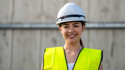 Smiling woman in hard hat and vest