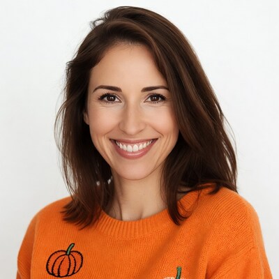 Smiling woman in orange pumpkin sweater