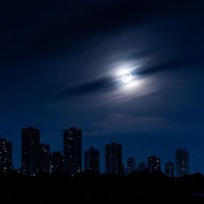 Full Moon Over City Skyline Silhouette