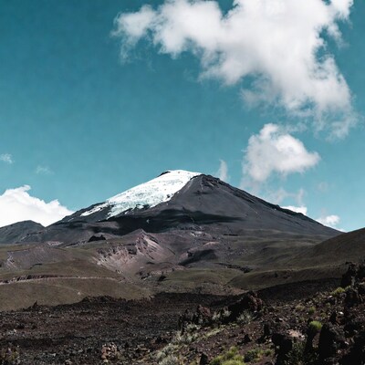 Snow-capped volcano under blue sky