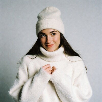 Woman in white beanie and turtleneck