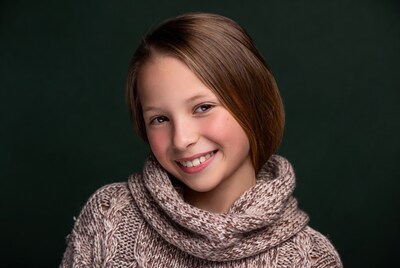 Smiling girl in turtleneck sweater