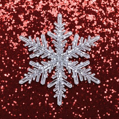 White Snowflake on Red Glitter Background