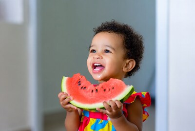 African-American baby girl eating watermelon