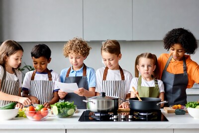 Diverse children cooking vegetables in kitchen