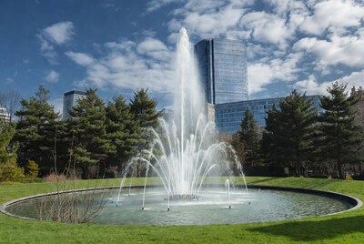 Fountain spraying with skyscrapers and trees
